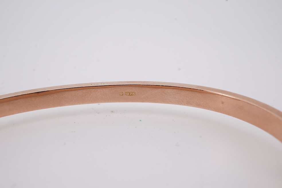 An Edwardian 9ct gold, sapphire and diamond set hinged bangle, Chester, 1909, interior diameter 57mm, gross weight 10 grams. Condition - poor